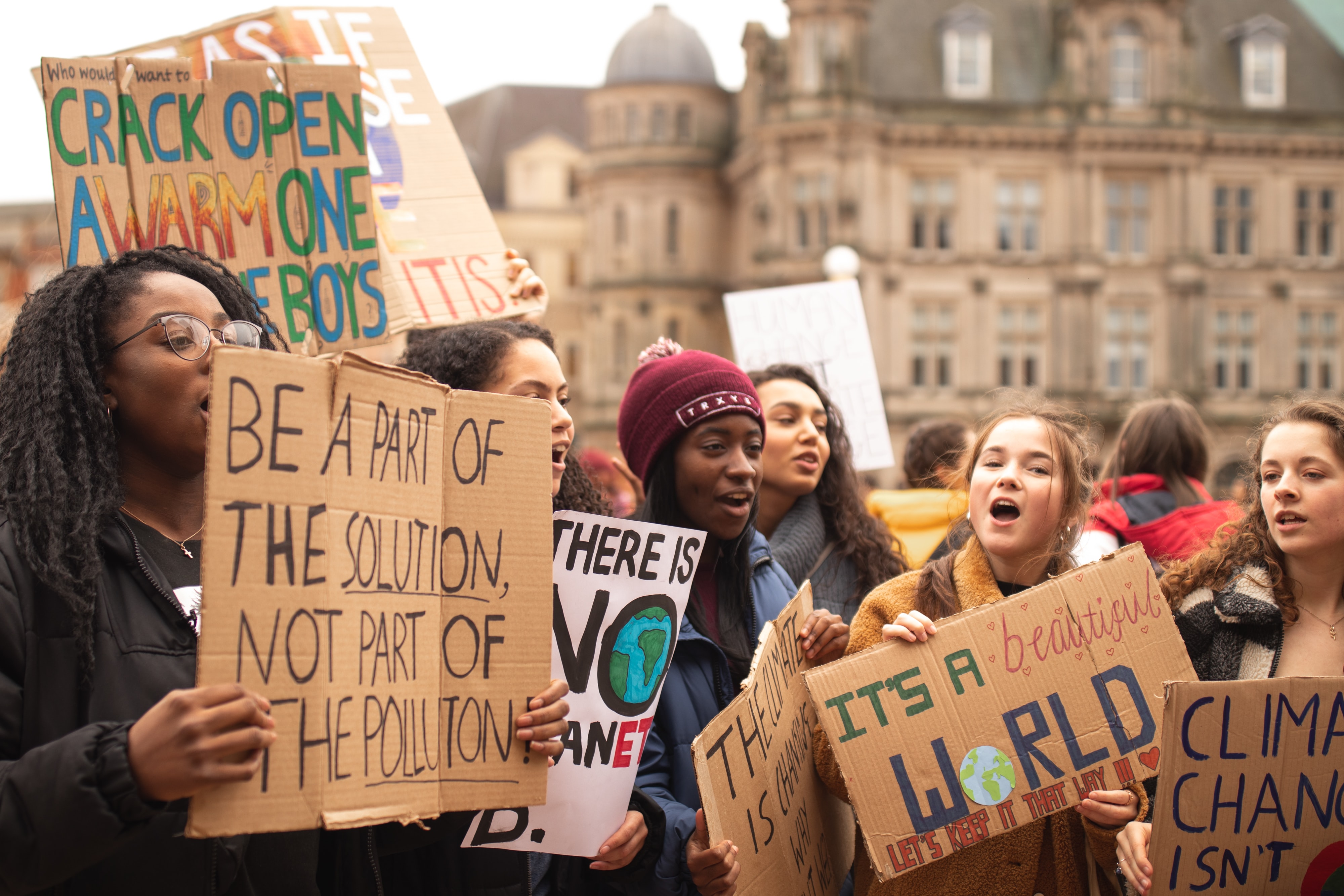 Young women holding climate change protestsigns